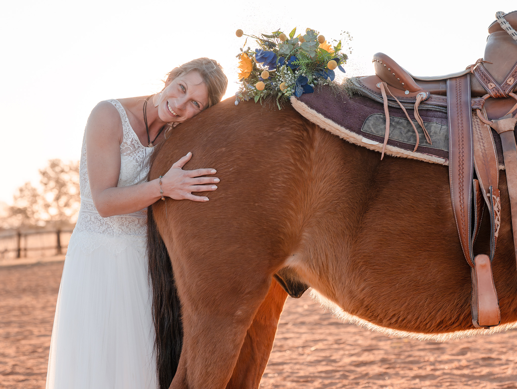 Bride hugging horse with flowers