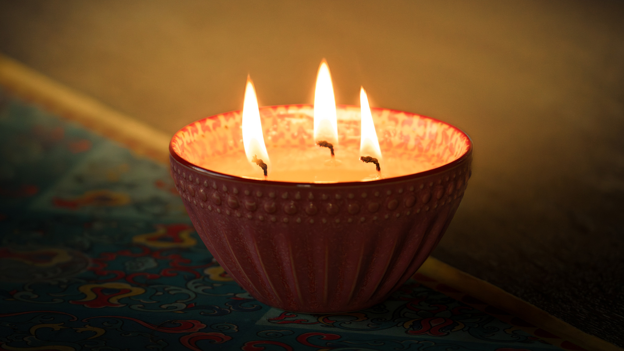 An image of a medium Stephani's Scented Candle burning