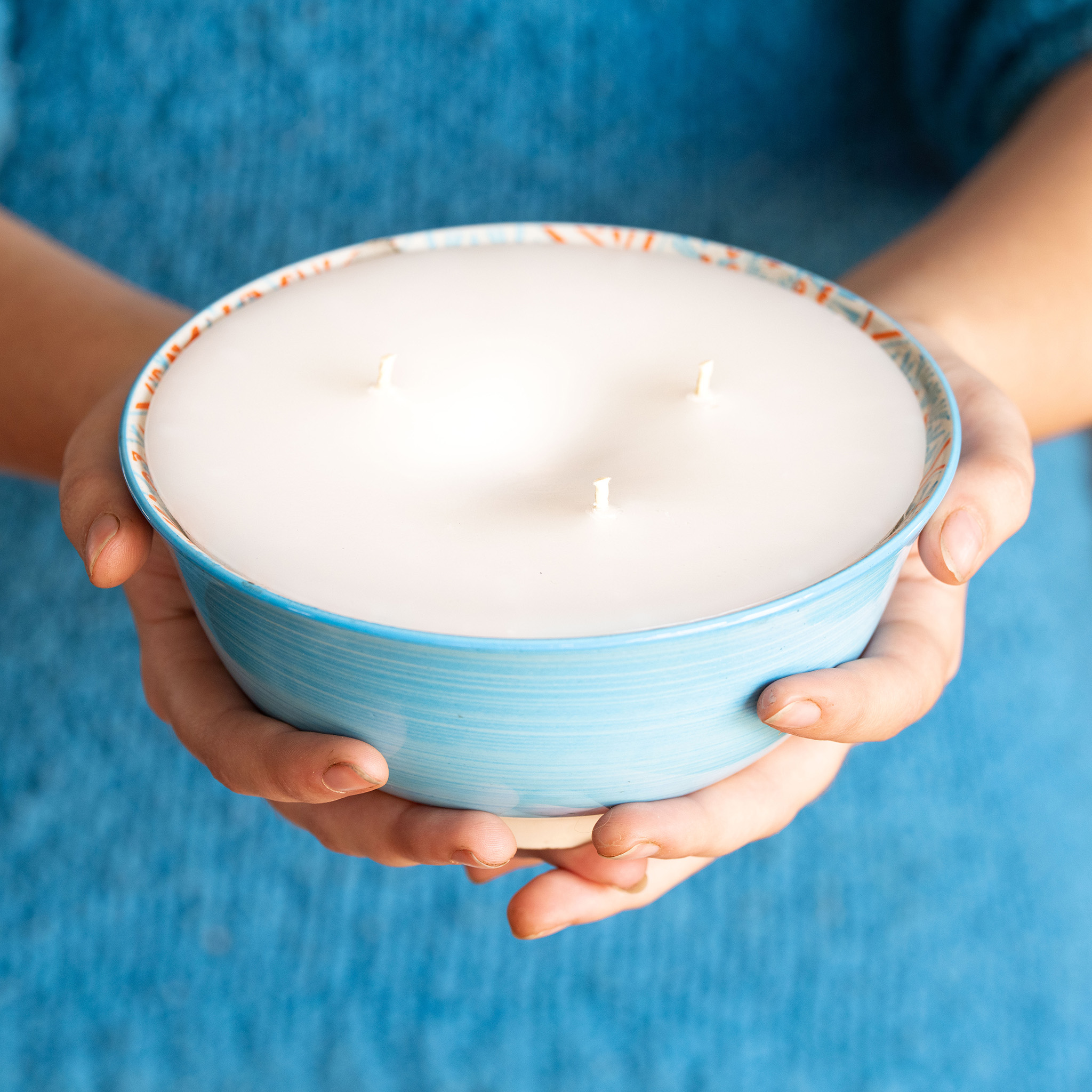 Hands holding a Stephani's Scented Candle as a gift