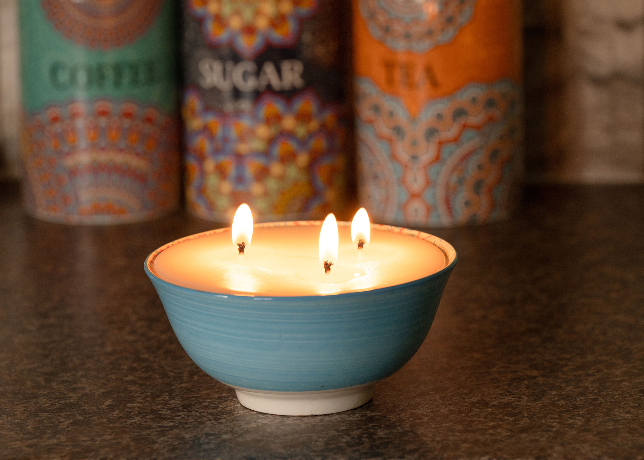 Blue candle with colourful background