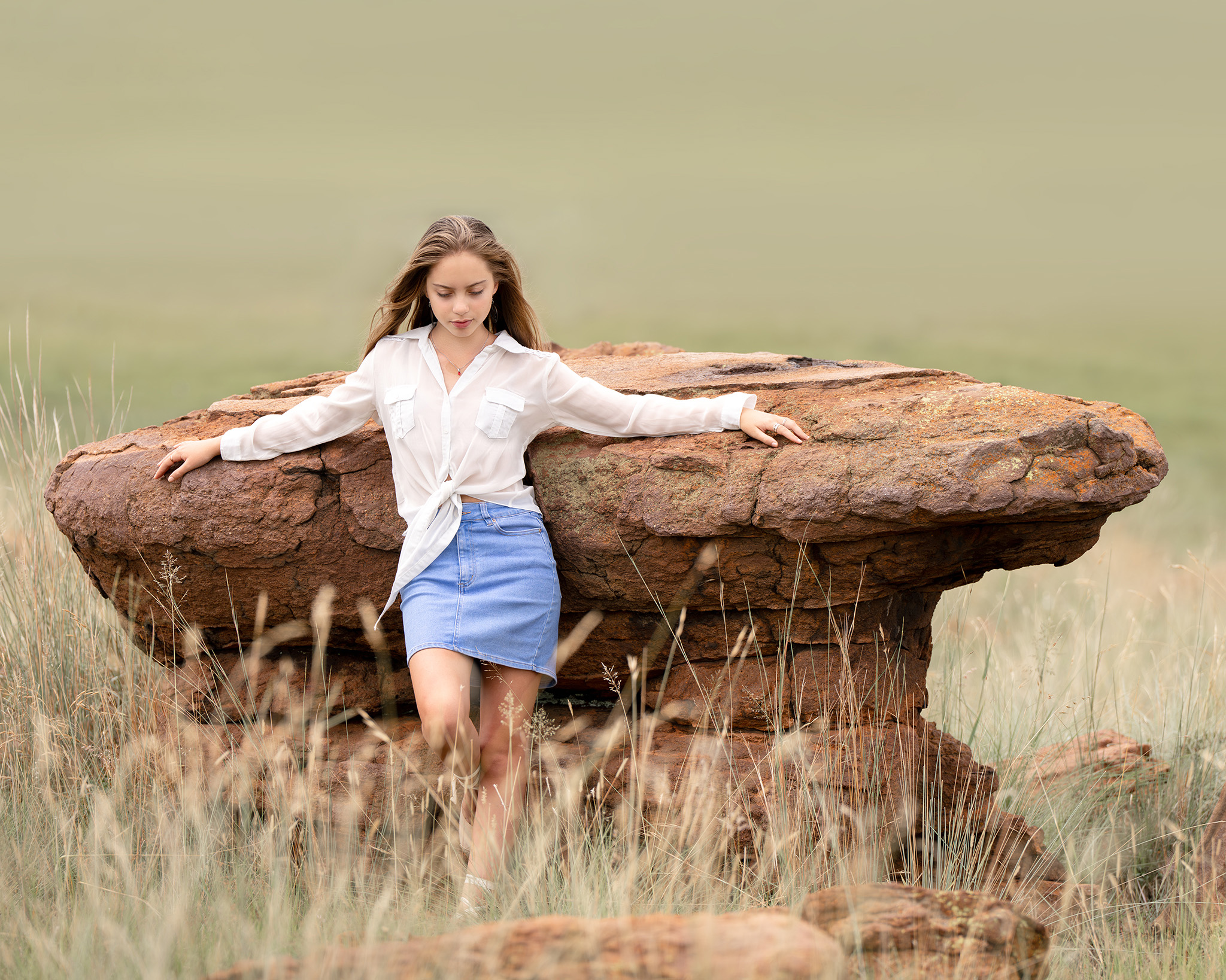 Model posing against a rock