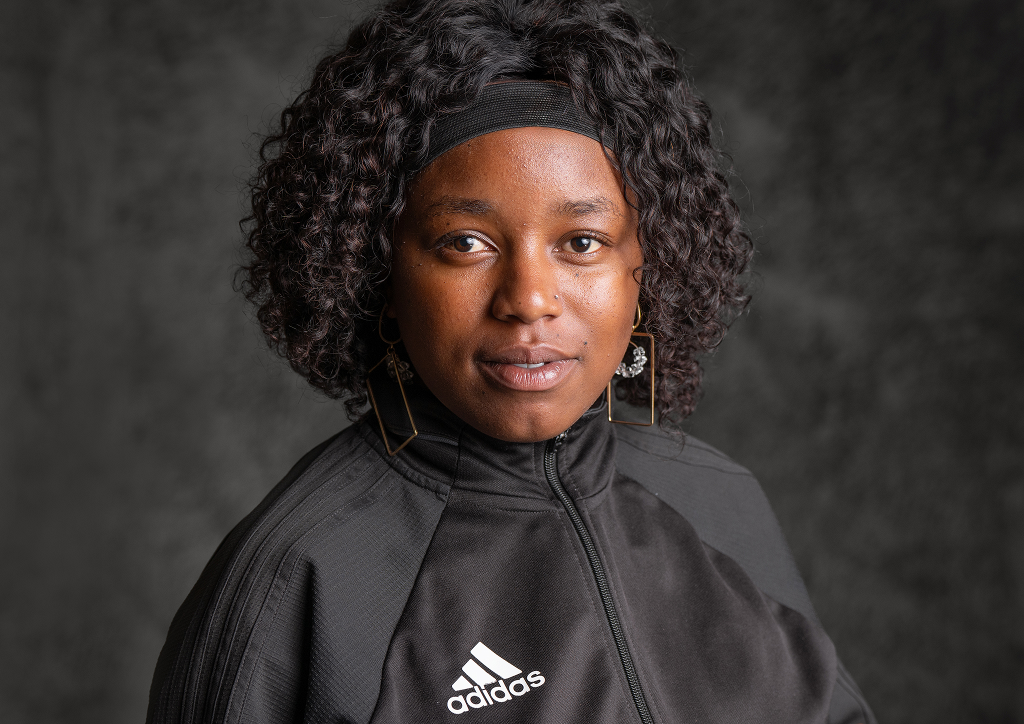Headshot of a student against a textured grey background