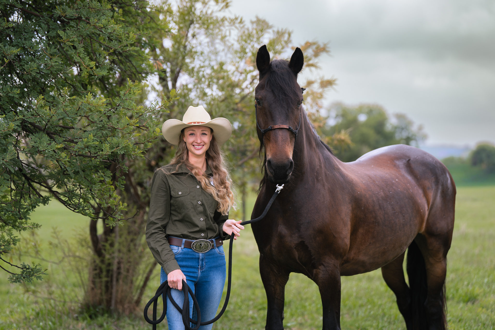 Image of a female horse training graduate student and her horse