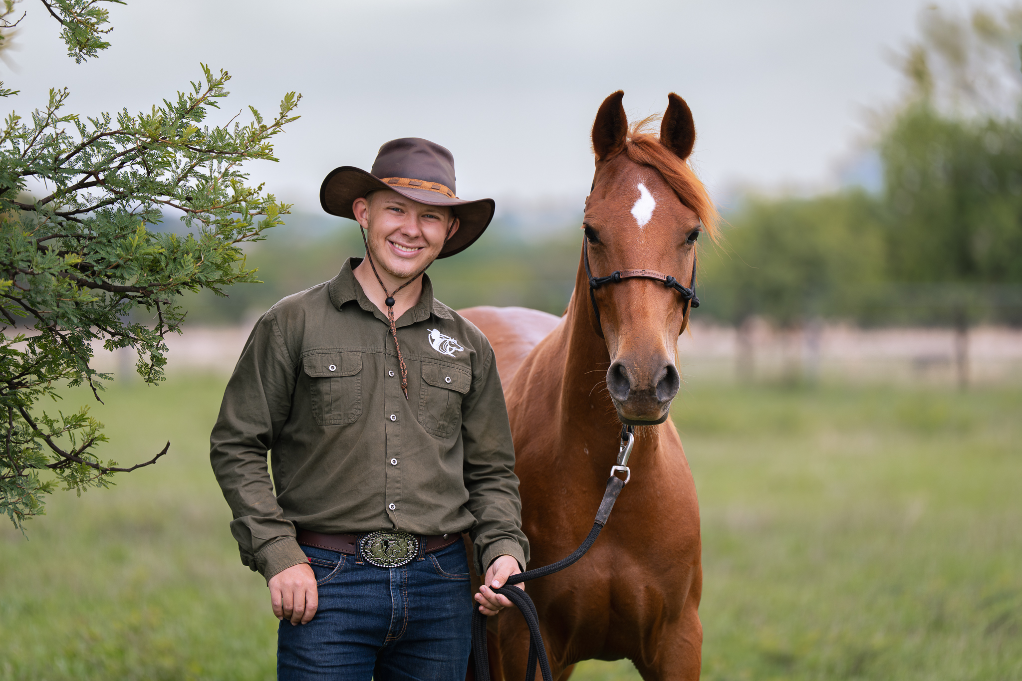 A male Smith Horsemanship Student posing with his arabian mare