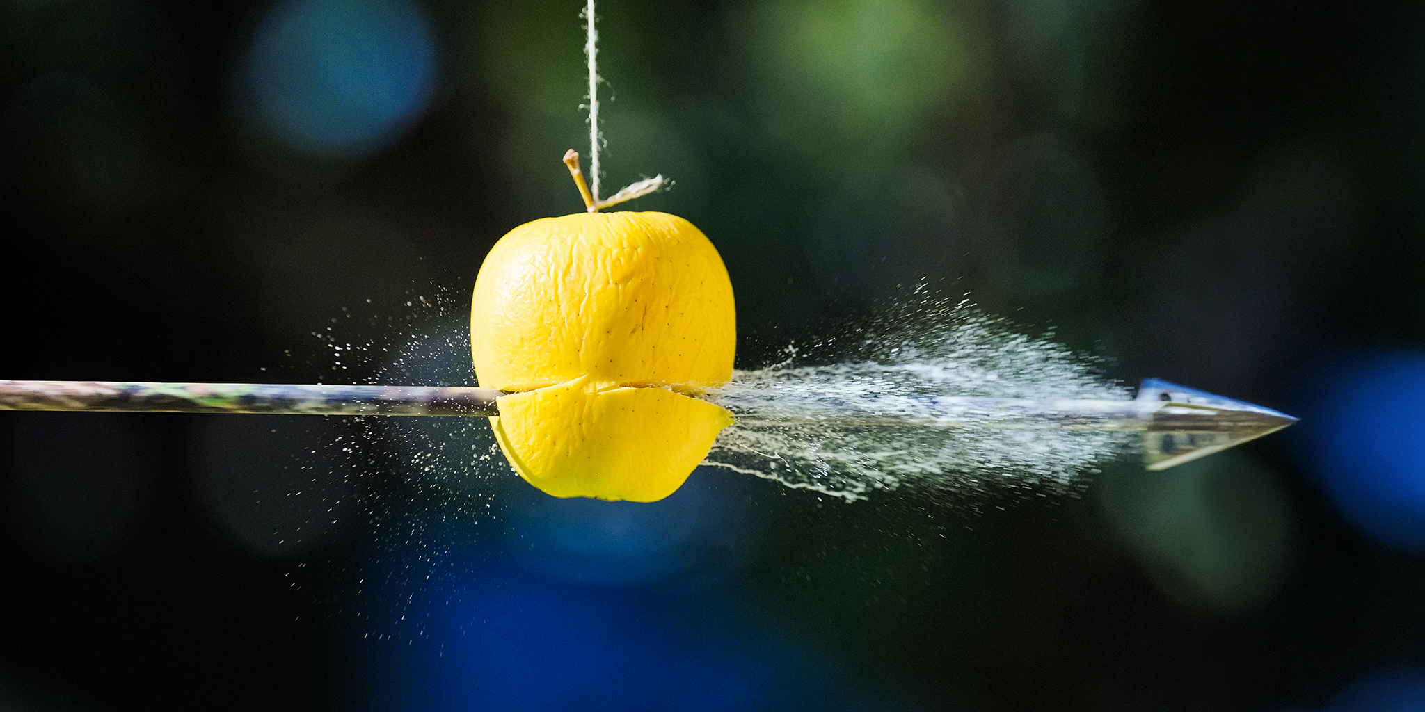 High speed photography of an arrow bursting through an apple