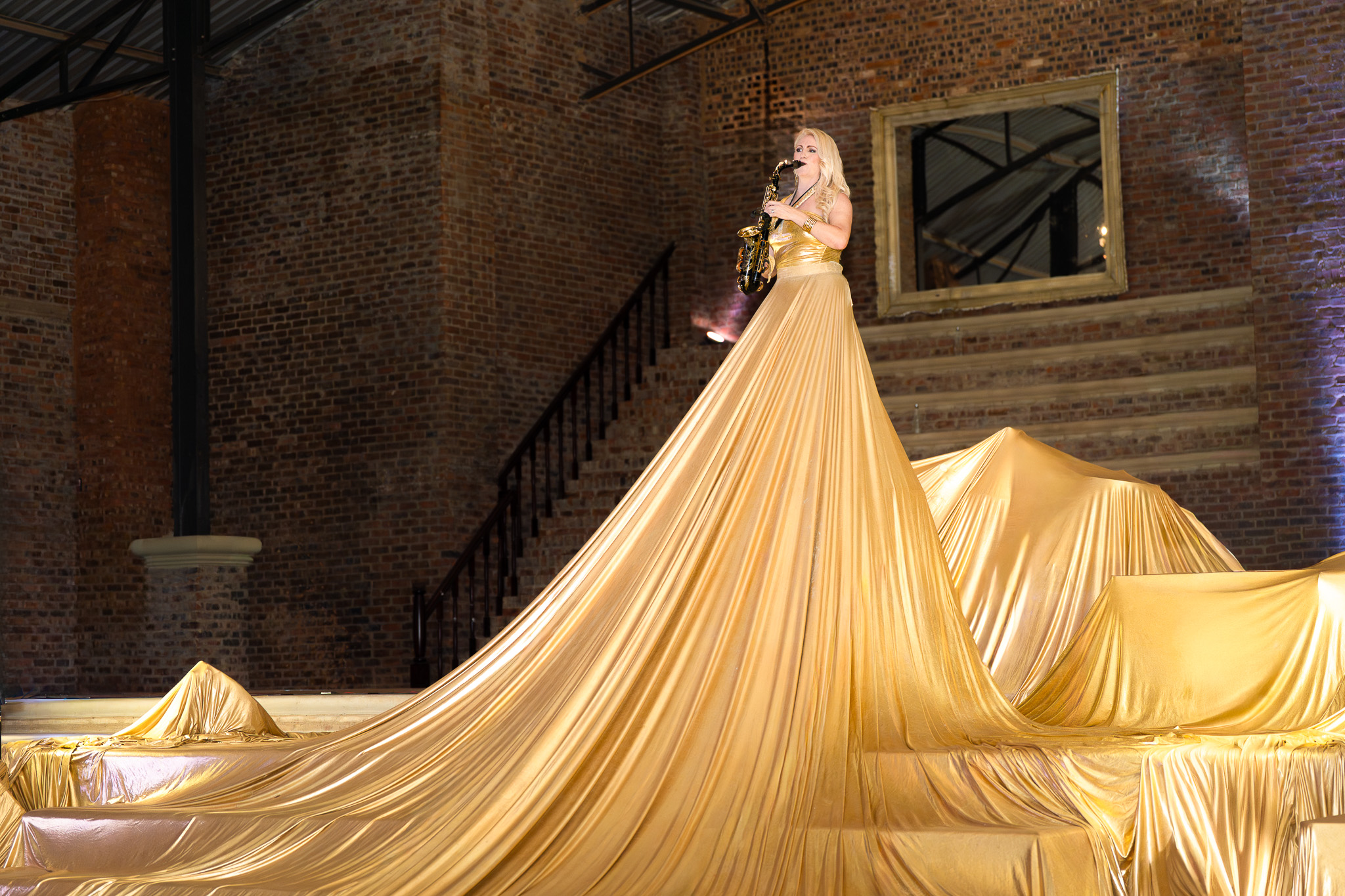 Event image of a saxophonist in a golden dress