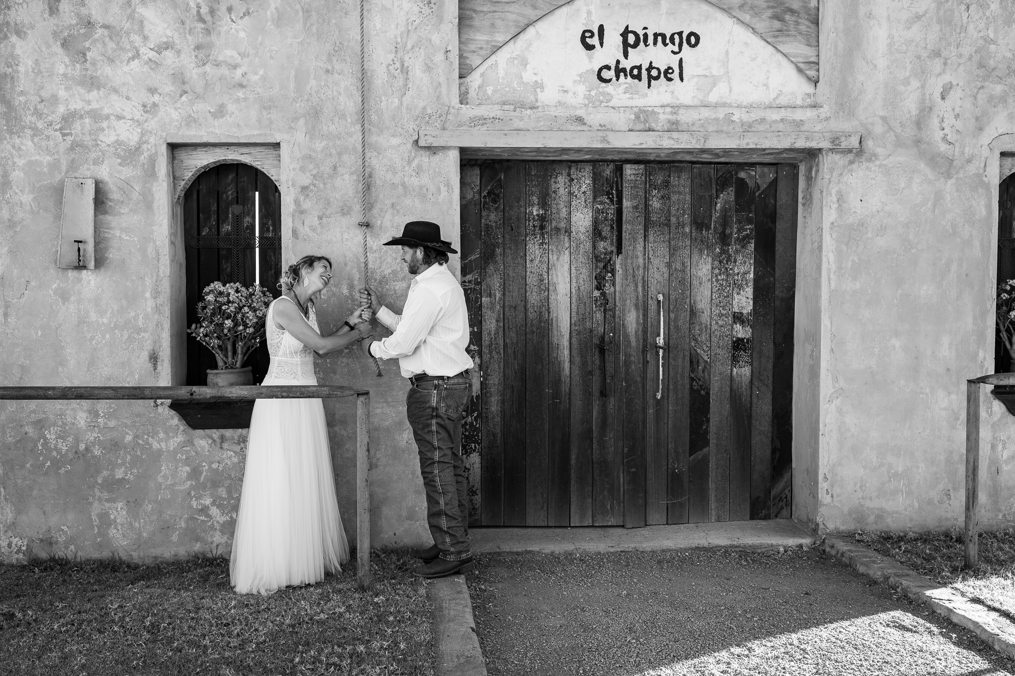 Black and white image of a couple at a ranch wedding