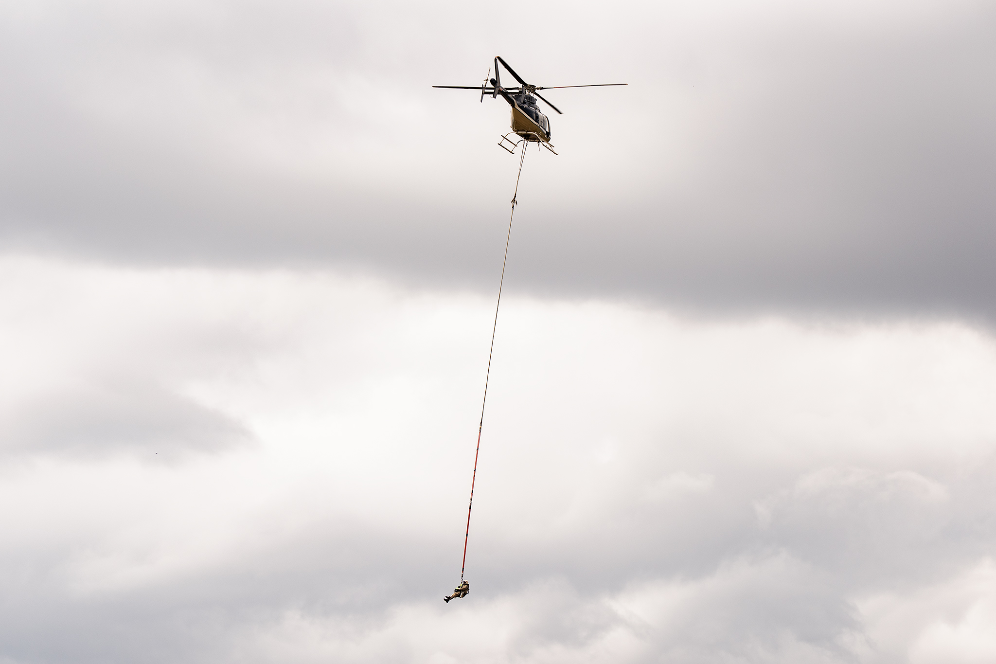 Image of a chopper carrying a worker on s line