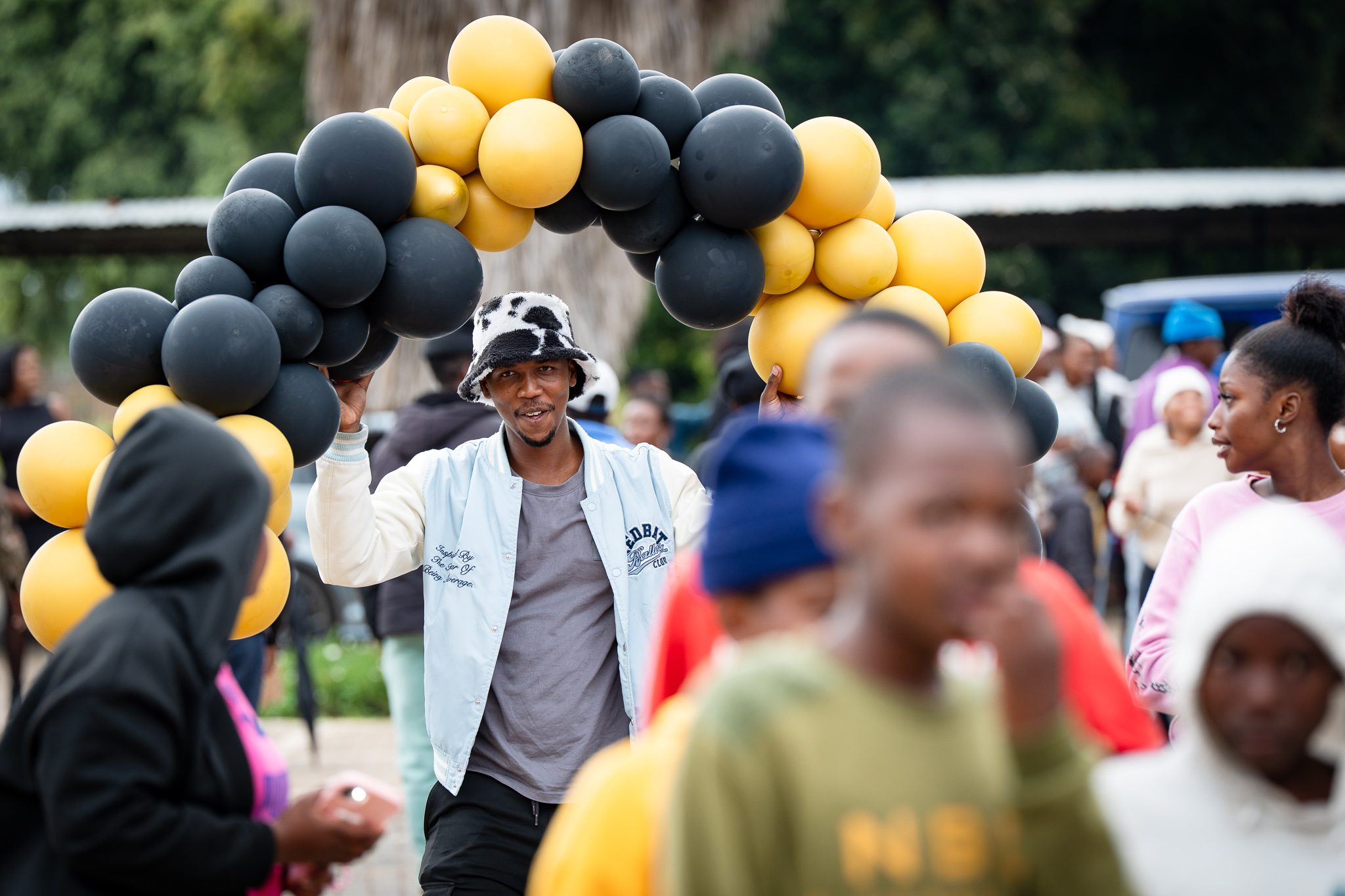 Event image of a man carrying baloons