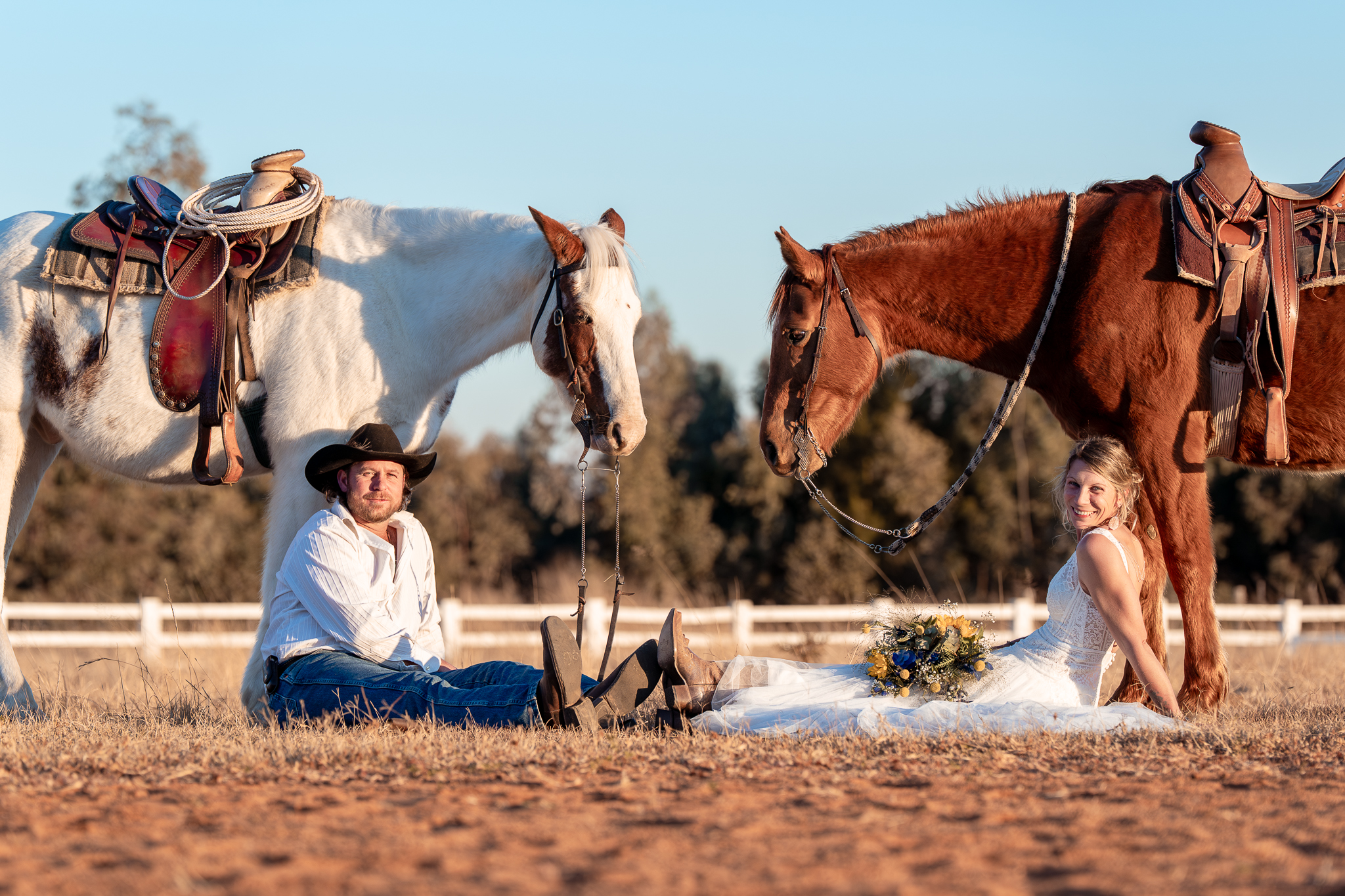 Bride and groom posing with horses