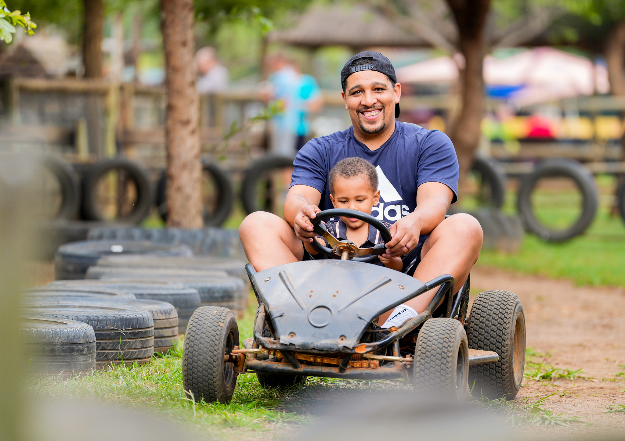 A father and son riding go carts at the Pretoria Boeremark