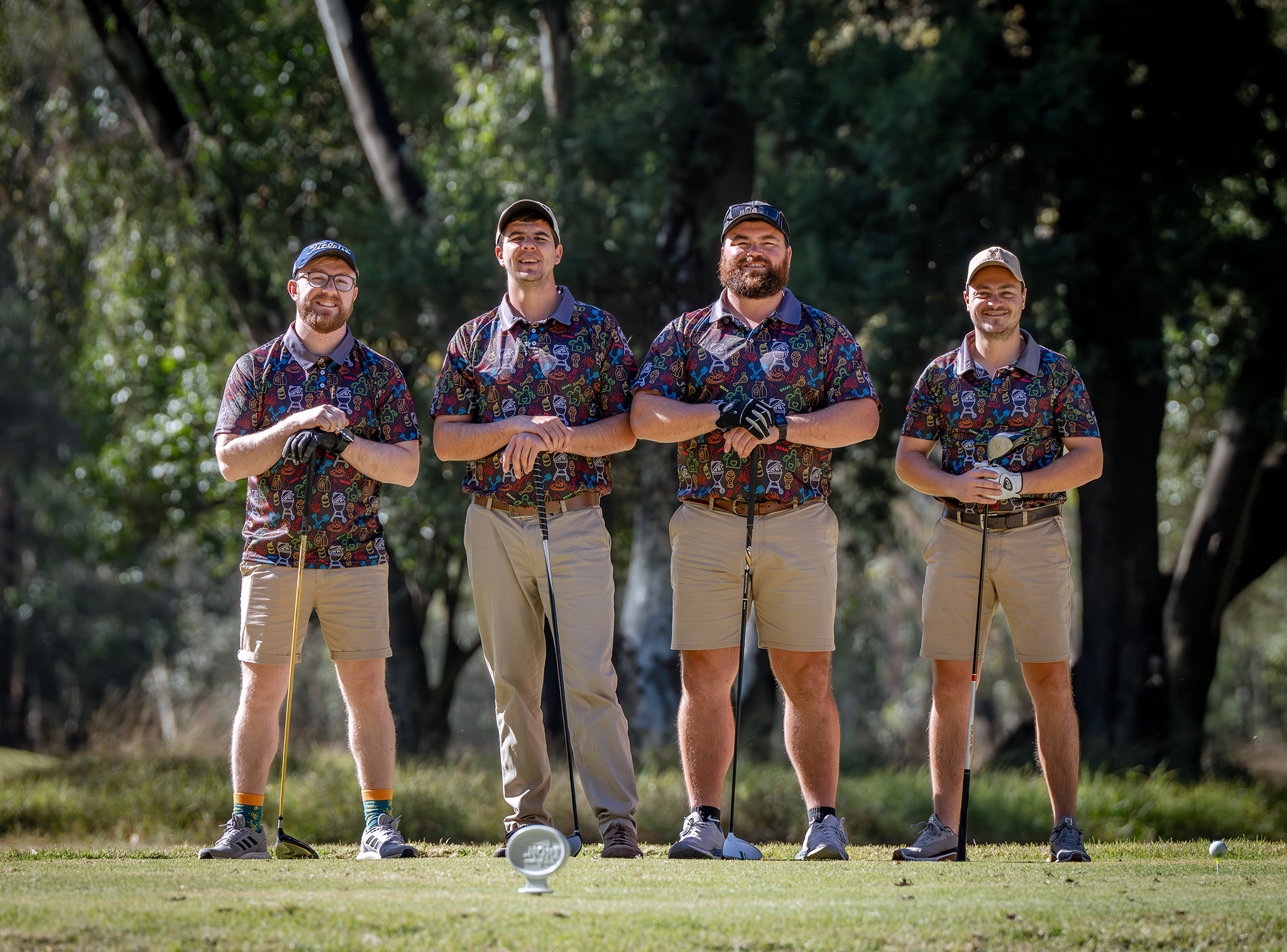 Golf day group posing with their clubs