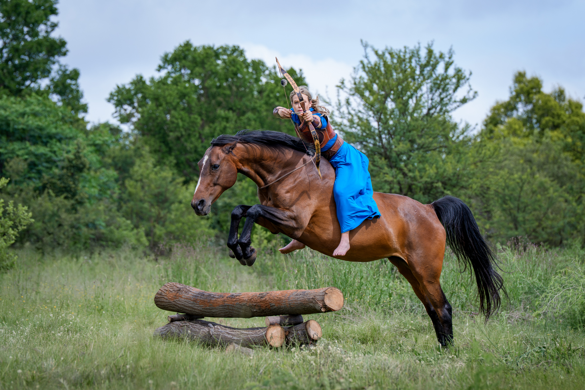 Professional profiler image of an equestrian archer performing her stunt