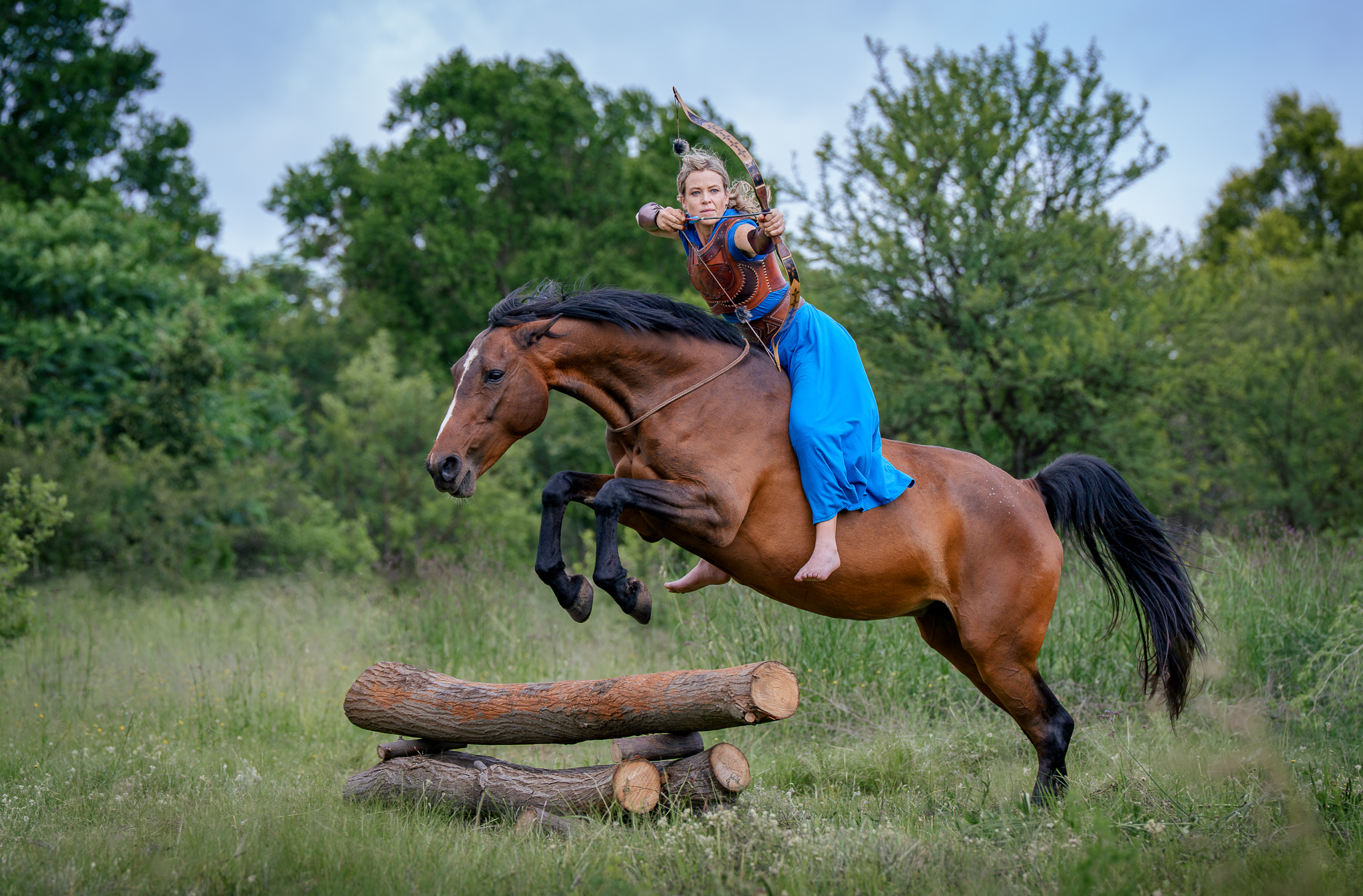 Mounted archer jumping an obstacle on horseback during a lifestyle equestrian photoshoot