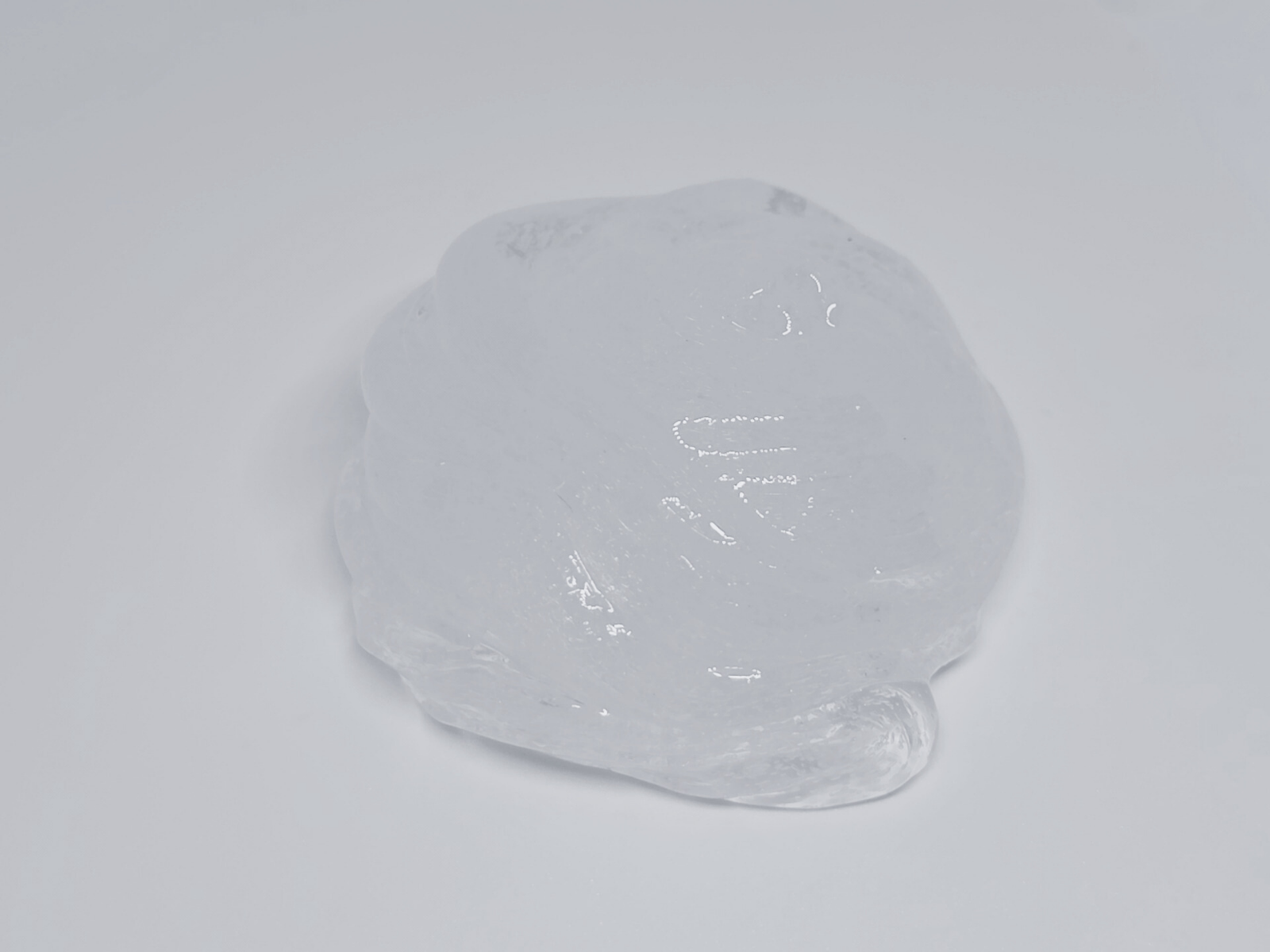 A transparent swirl of clear slime from Lilakawaii by Slime Design