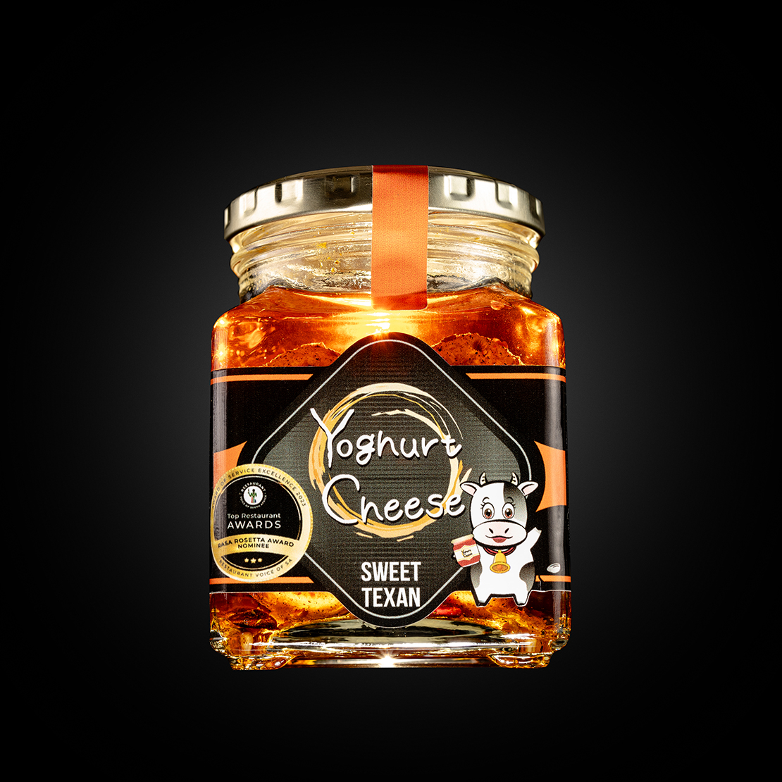 Product image for a food product in a jar on dark background