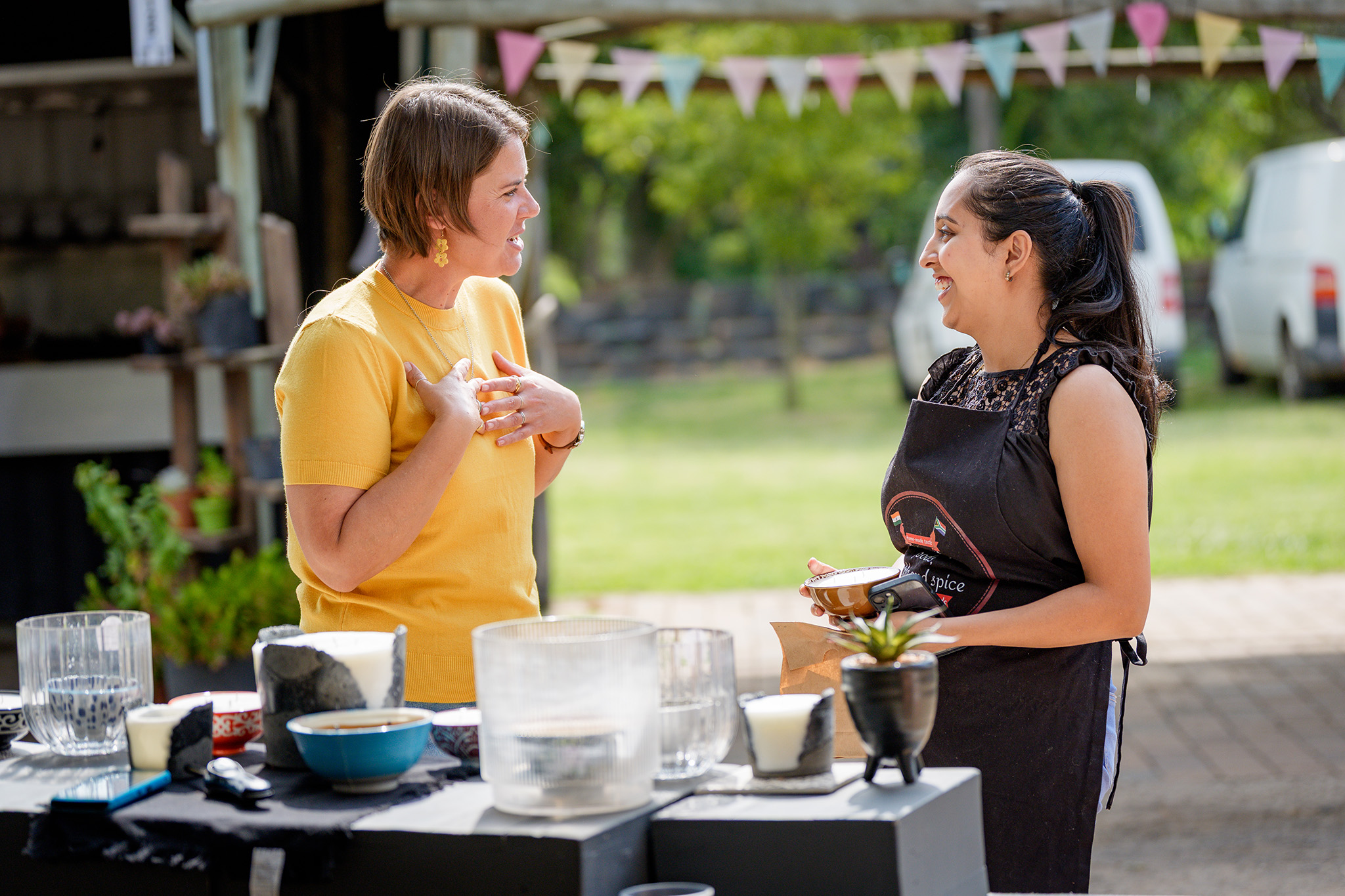 A vendor and customer share a moment at the Pretoria Boeremark