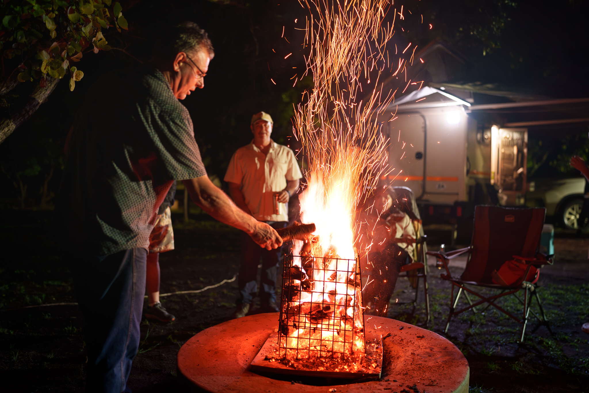 Campers around the fire at Impala Game Ranch in Dinokeng