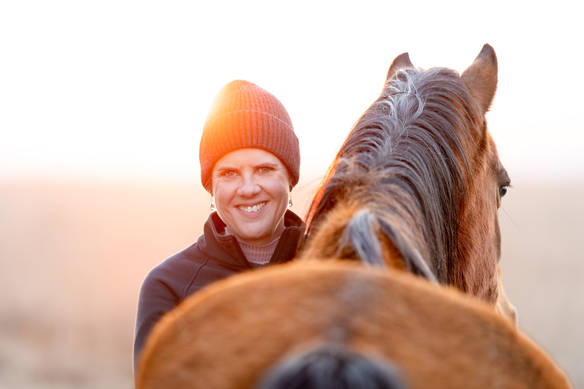 Portrait of a lady with her horse at sunrise