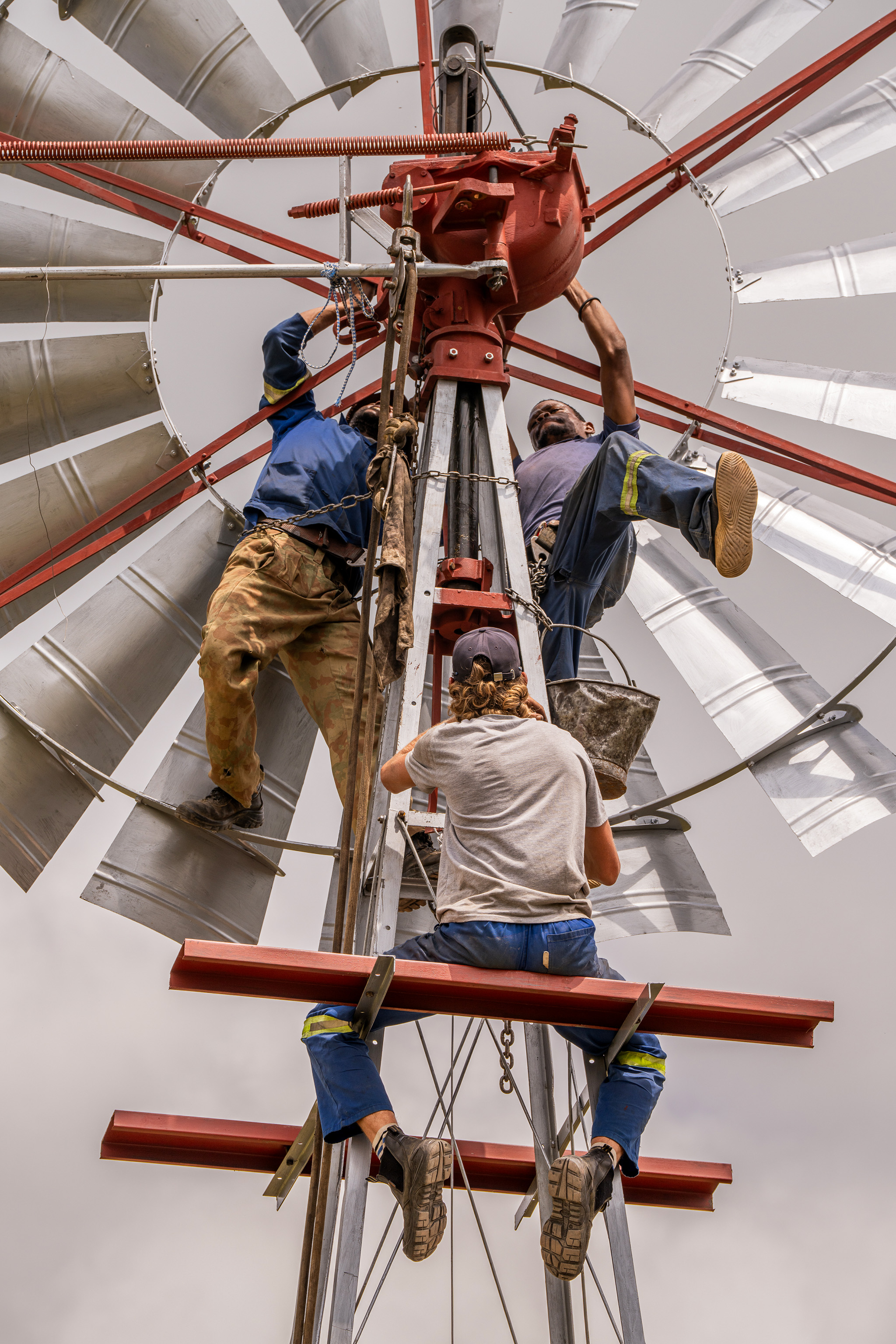 Three men working on a windmill