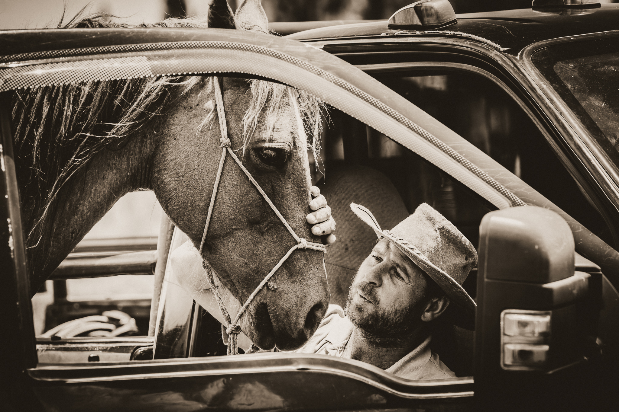 Sepia image of a man and a horse