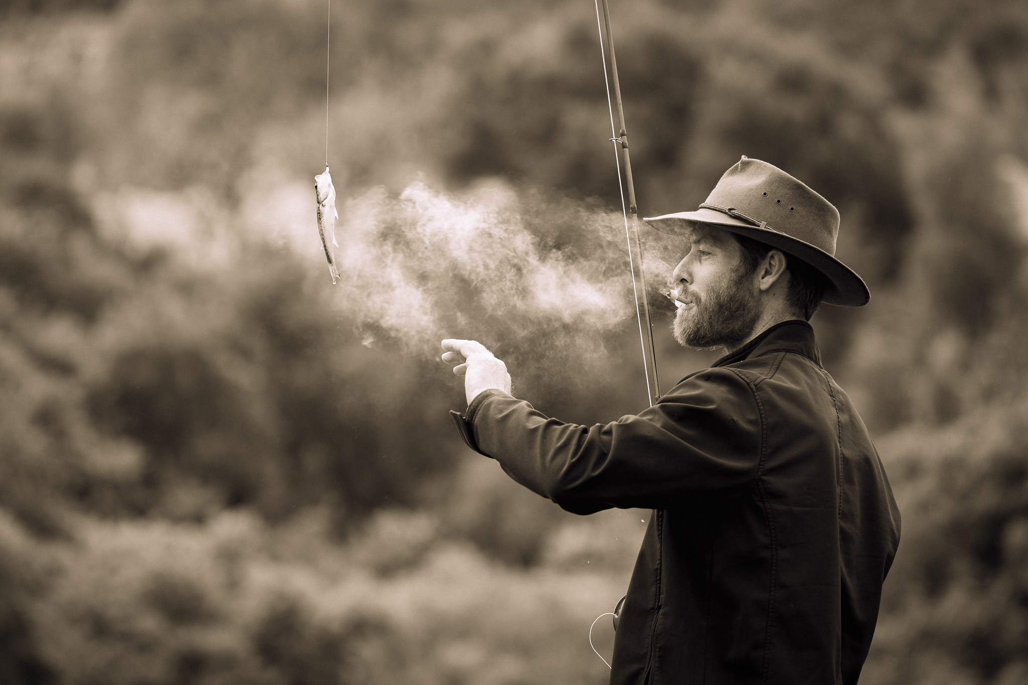Portrait of a man with fishing rod and cigarette