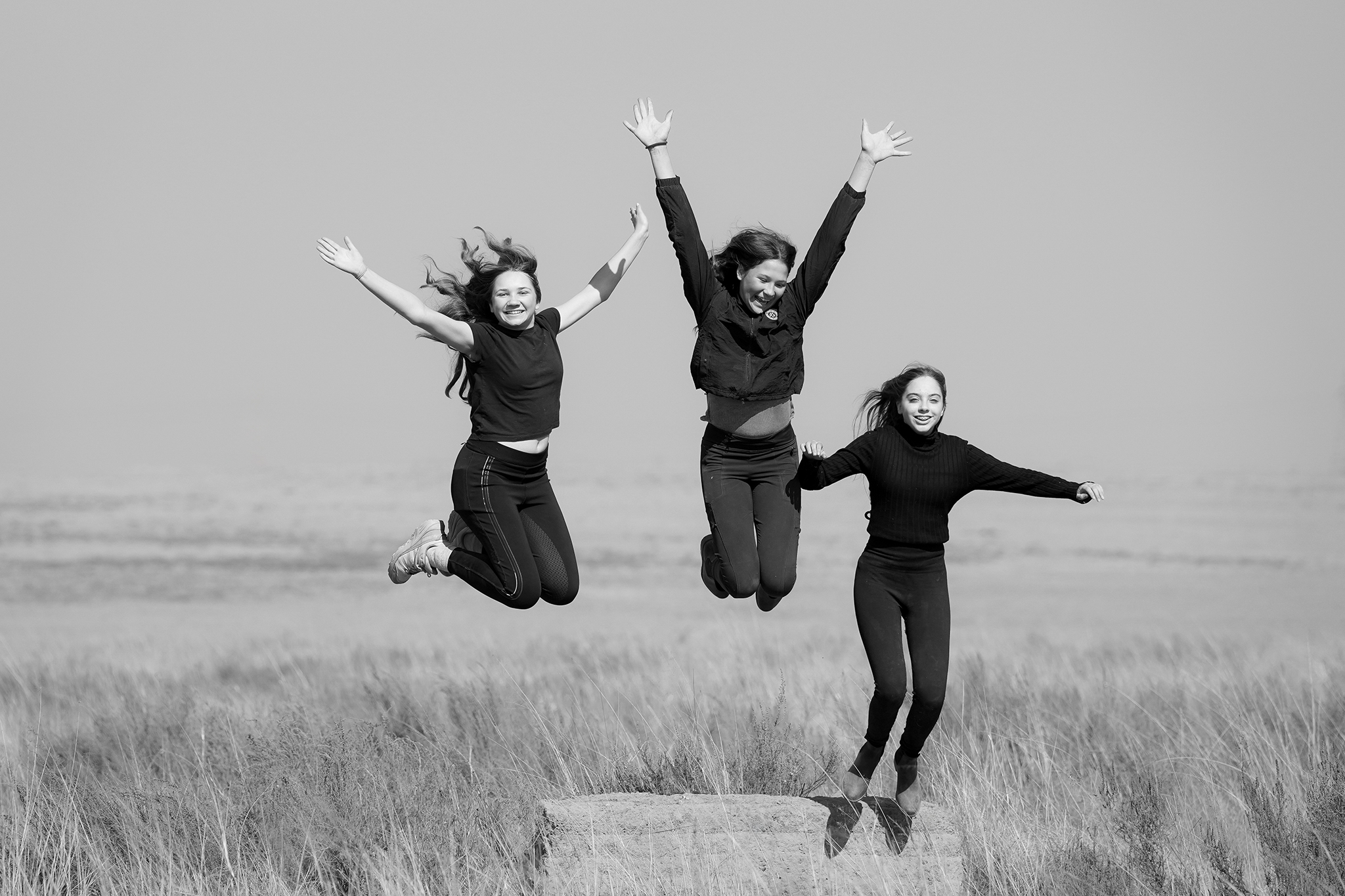 Black and white image of girls jumping