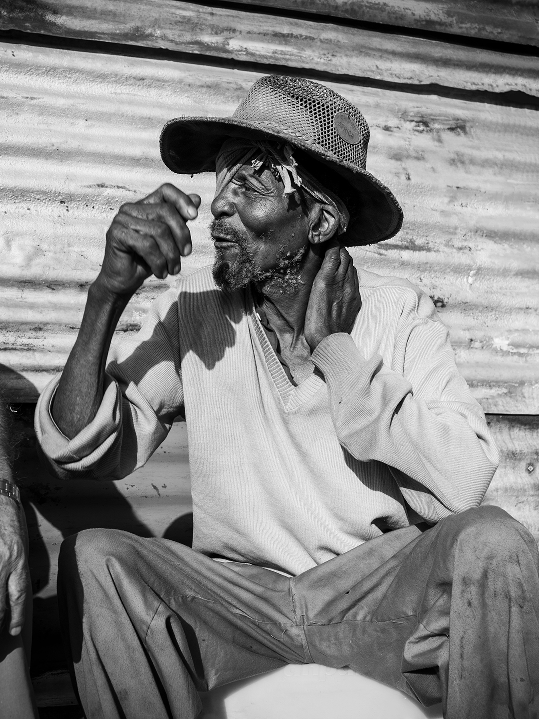 Black and white image of an old man telling a story