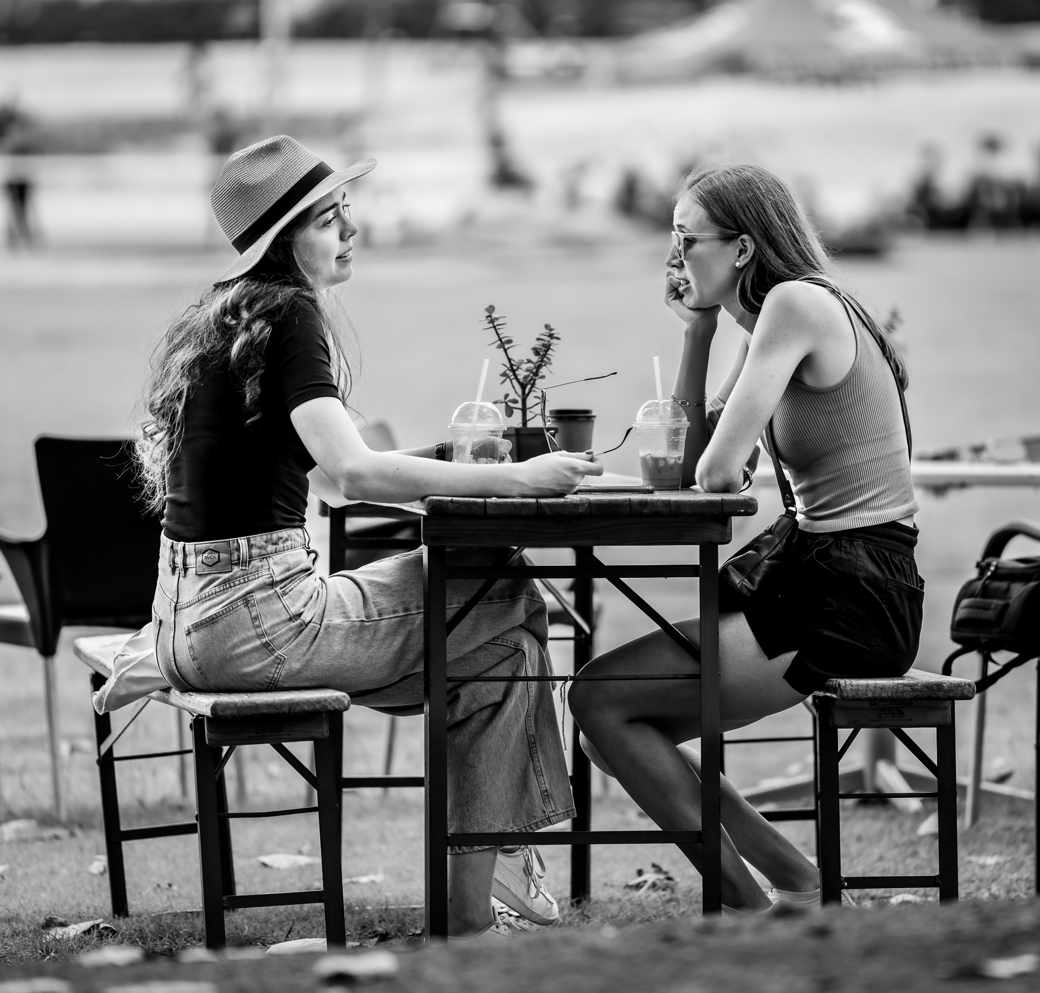 Black and white image of young ladies talking at a table