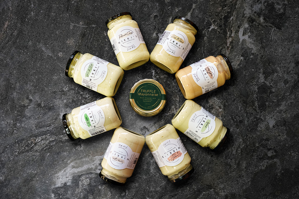 Bottles of hand crafted mayonaise on a marble counter