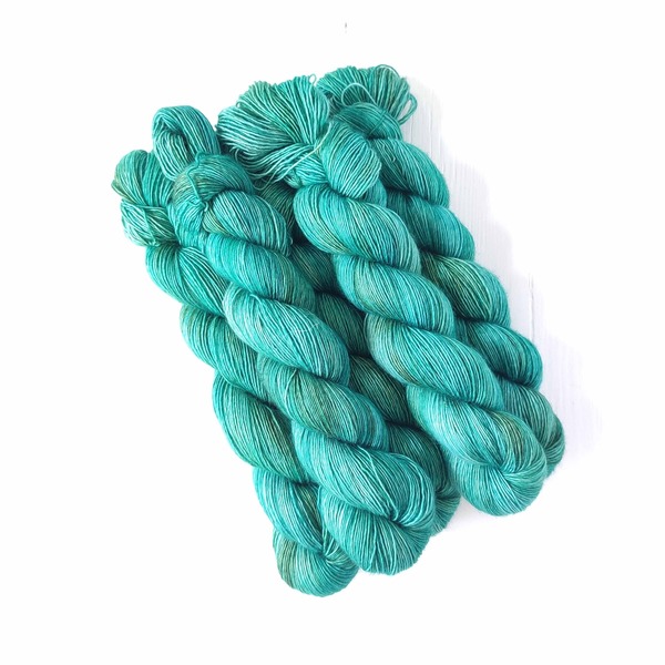 Verdigris is a colour that I have long thought about, particularly in terms of how to incorporate the beautiful jade blues and greens, and the greyish greens that the name hint at.This colourway attemps to combine all of the above in a luscious, jewel-like combination to create a medium-dark subtly variegated skein.
Care Instructions: For long term fibre and colour care a gentle, PH neutral detergent (preferably natural/organic) and cold water rinse is recommended. Refrain from excessive wringing. Dry flat, avoiding prolonged exposure to harsh sunlight.